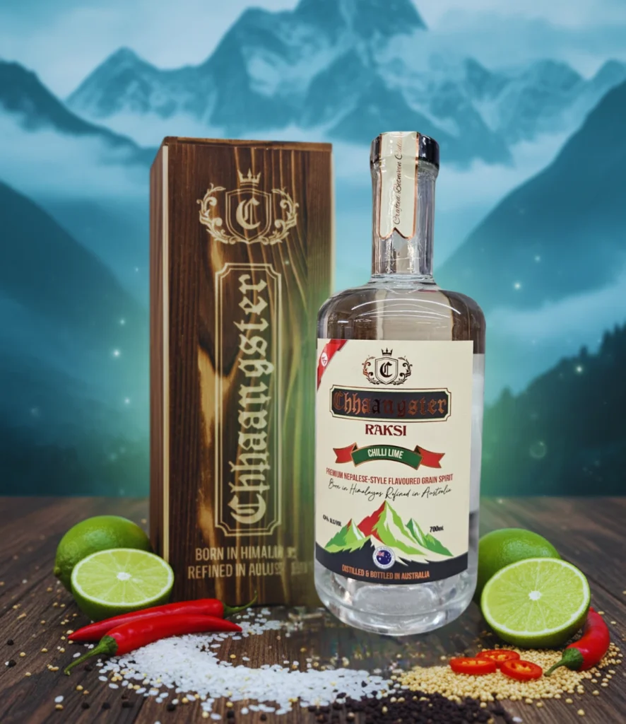 Chhaangster Chilli Lime Raksi 700ml bottle with red chillies, lime halves, rice grains, and wooden gift box, premium Nepali-style flavoured grain spirit, 43% ABV.