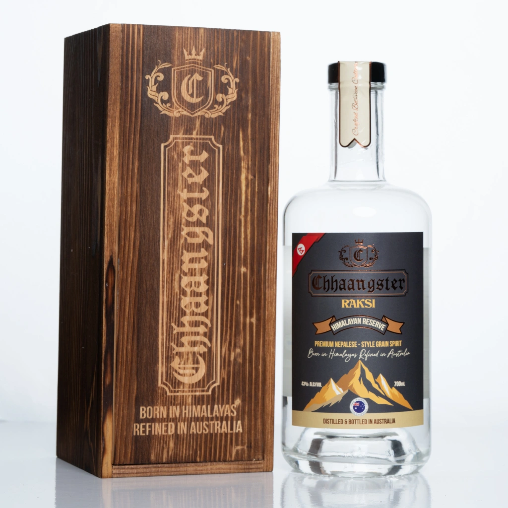 Chhaangster Raksi bottle and engraved wooden box showcasing Himalayan Reserve spirit